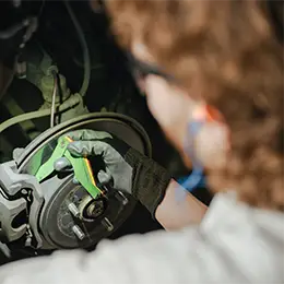 Les Schwab technician inspecting brakes