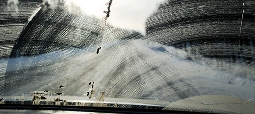 Windshield smeared with snow and dirt