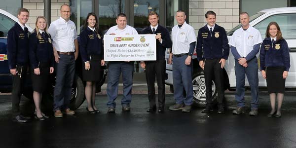Les Schwab employees and Oregon FFA members standing in front of a Les Schwab store.