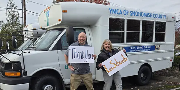 YMCA of Snohomish County employees in front of fleet vans