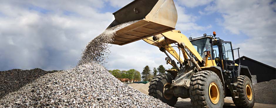Heavy equipment loader moving gravel.