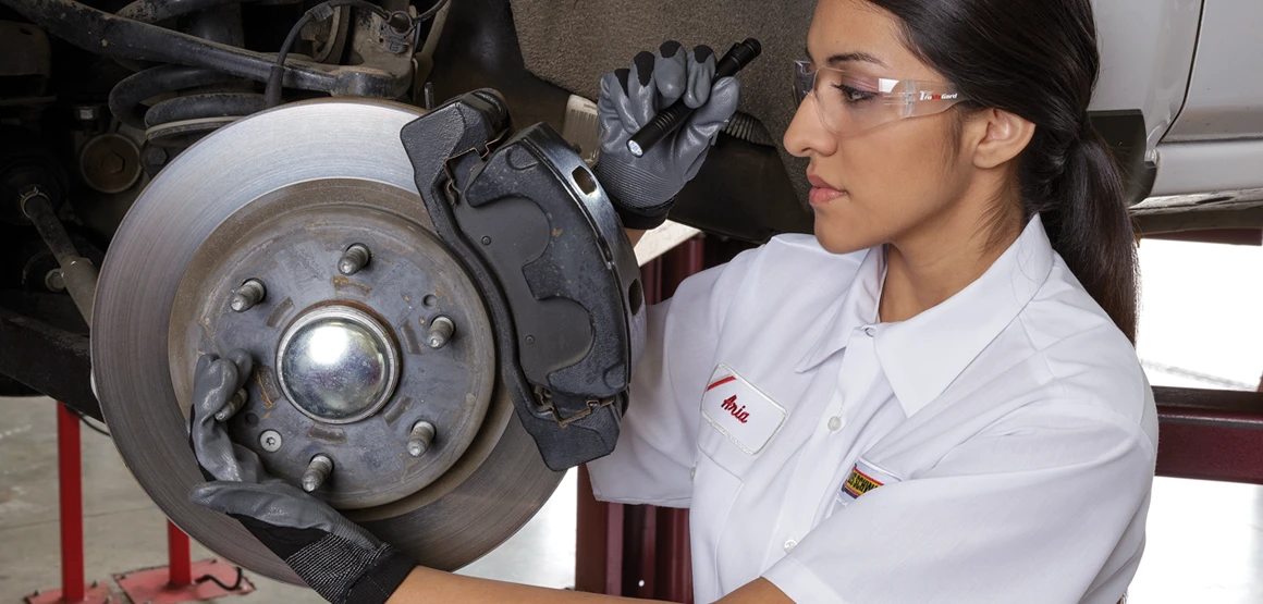 Les Schwab technician working on brakes