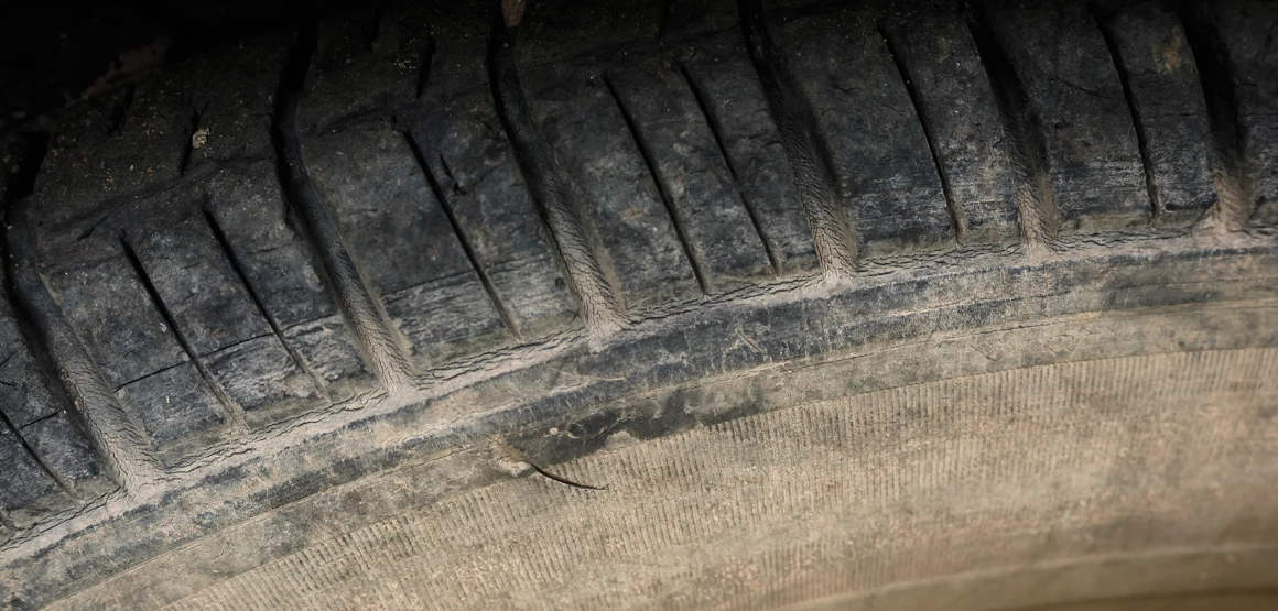Older tire showing signs of age with fading colors on the sidewall and tread