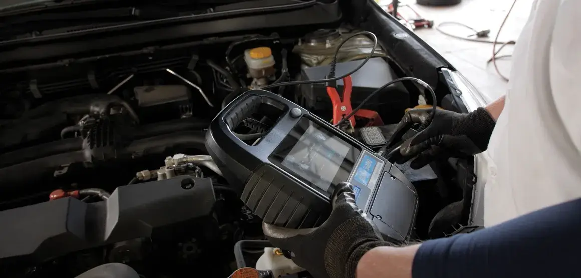 Technician checking a battery