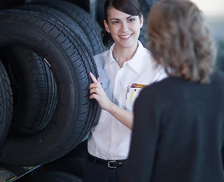 Les Schwab technician discussing tire options with a customer