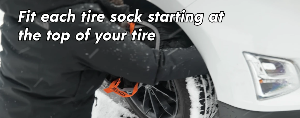 Person fitting a tire sock over the top of a tire.