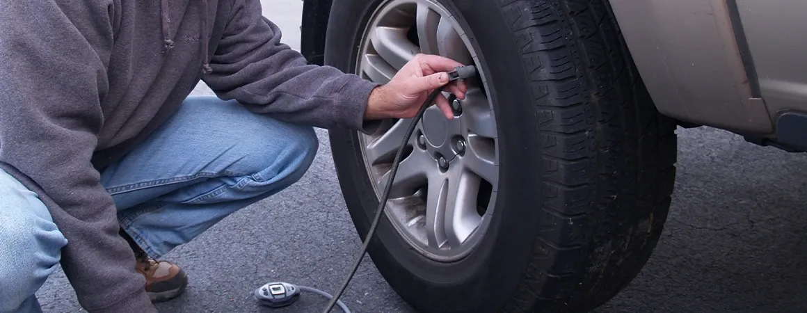 Person adding air to their tire