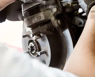 Technician working on car brakes