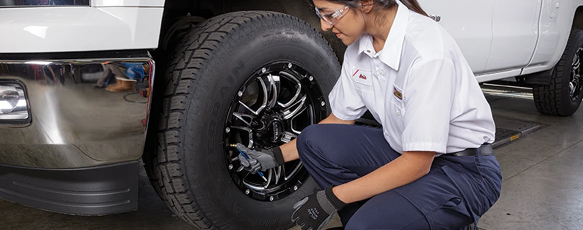 Les Schwab employee checks tire pressure