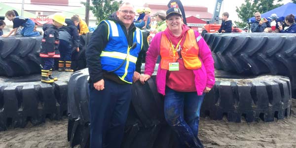 Woodland Les Schwab manager Brien Rose and his wife supervising children playing on giant tires at Dozer Day in Vancouver.