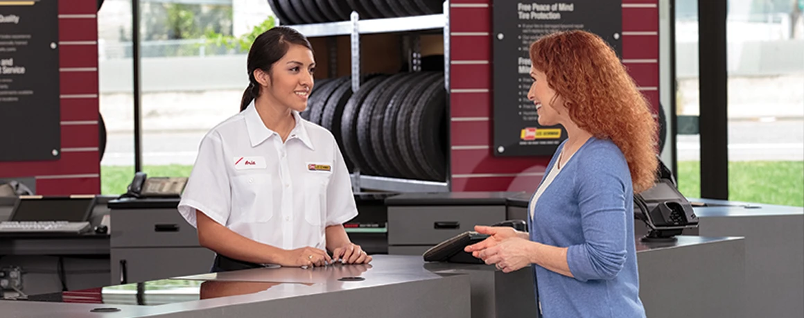 Les Schwab employee discusses tire options with a happy customer