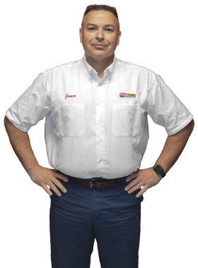 A Les Schwab technician stands arms akimbo. His name is James