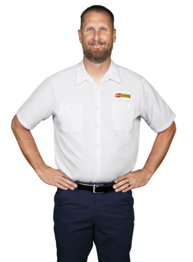 A Les Schwab technician stands arms akimbo. His name is David